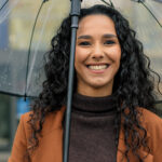 Woman smiling in the rain in Coral Springs and [test_shortcode]